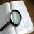 Dictionary and magnifying glass